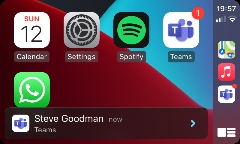 A notification shows on-screen from Teams, allowing the driver to tap the car  screen to read the message